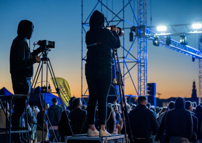 cameraman captures live event at sunset